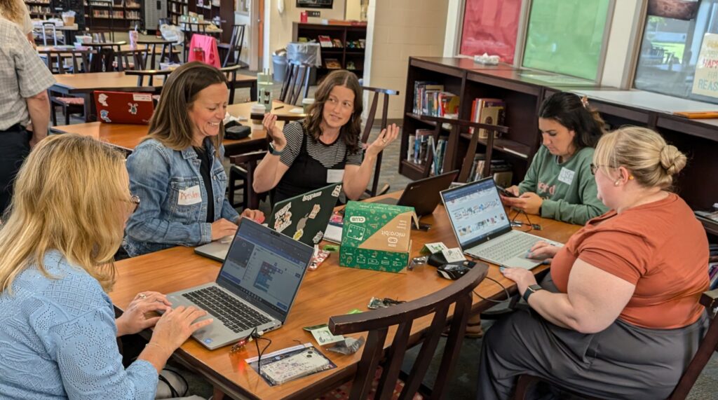  A group of teachers discussing CT technology tools at a table